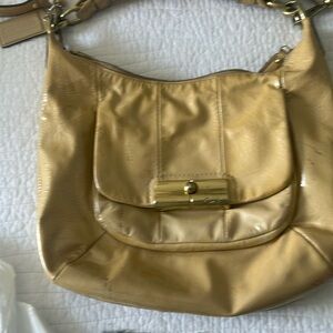 Coach bag with gold brass buckles.